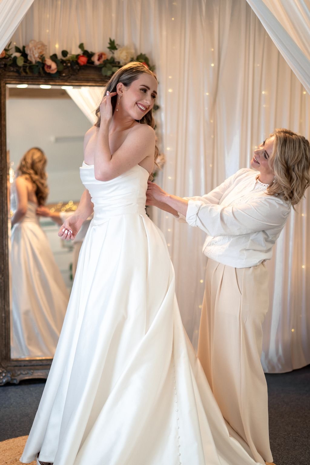Bridal stylist fitting a wedding dress on a bride at Olivia Rose Bridal